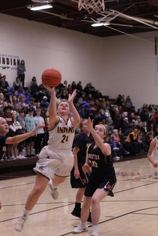 Senior Mattie Hutchison attempts a basket at a previous game against Manhattan. They will now take on Garden City on Feb. 2.