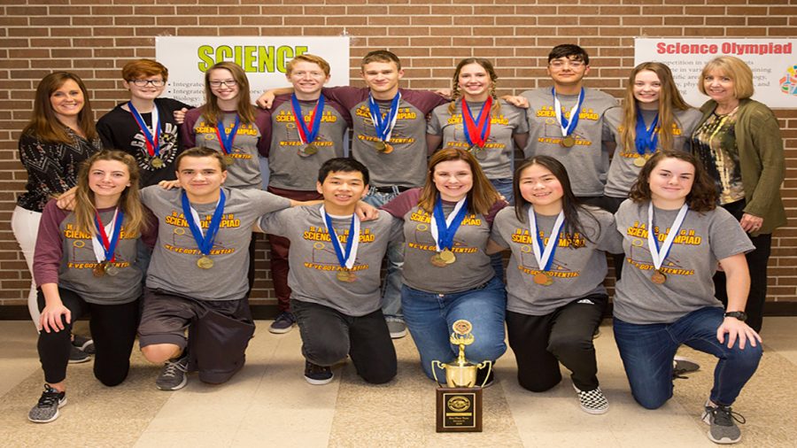 The Science Olympiad team poses with their trophy.