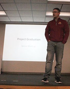 Math instructor Jerett Pfannenstiel explains Project Graduation to the senior class. 