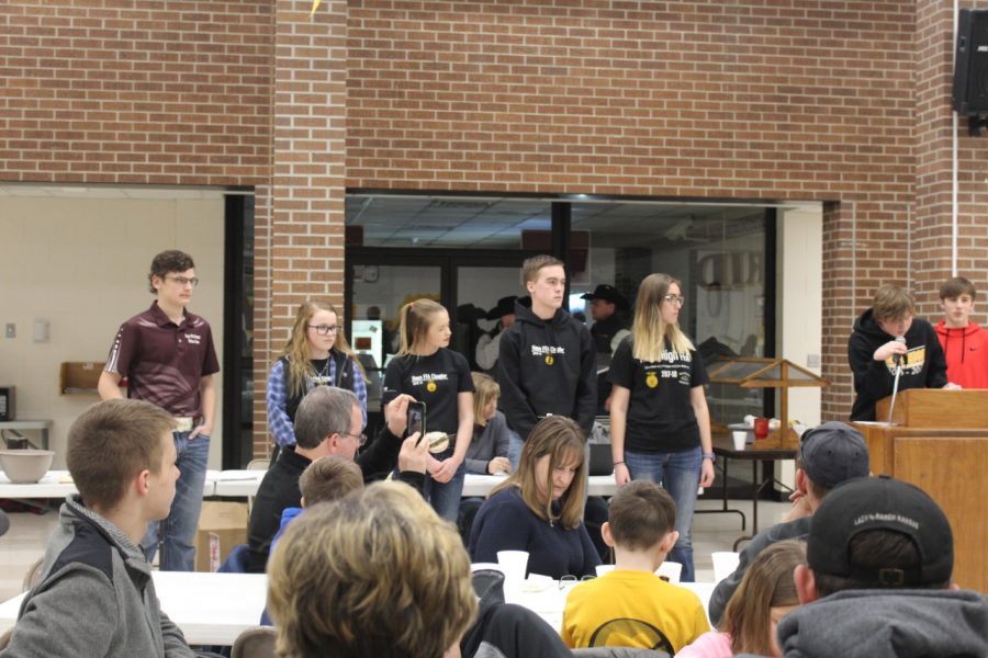 FFA students stand in front of the crowd waiting to be bought.