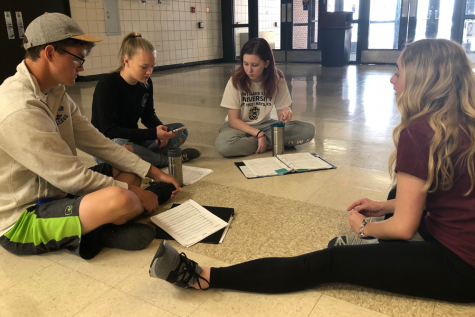 Seniors Zac Wyse, Rebecca Anderson, and sophomore Eliana Buller meet with acapella specialist Shelby Matlock to discuss scheduling and choreography. The Chamber Singers will compete against each other during the Pops Showcase concert on May 4th at 12th Street Auditorium.