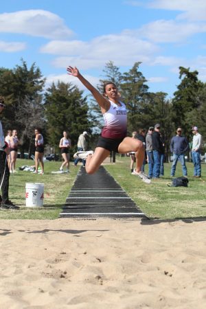 Junior Tasiah Nunnery triple jumps at a track meet in Larned. Recently, girls track took first at Abilene.