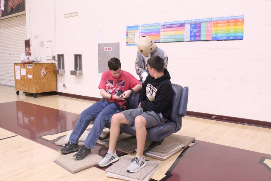 Sophomores Sean Gillock and Tucker Veach race to fasten their seatbelts. Senior Peyton Thorell watches over the two to insure the seatbelts are properly fastened before the two can run back to the starting line. This relay was meant to demonstrate how easy it is to buckle up and stay safe. 