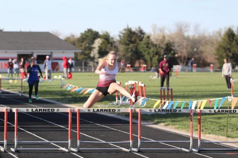 Sophomore Brooklyn Schaffer competes in hurdles at a previous meet at Larned. Schaffer and seven other athletes qualified for the 5A State Track and Field Championship.