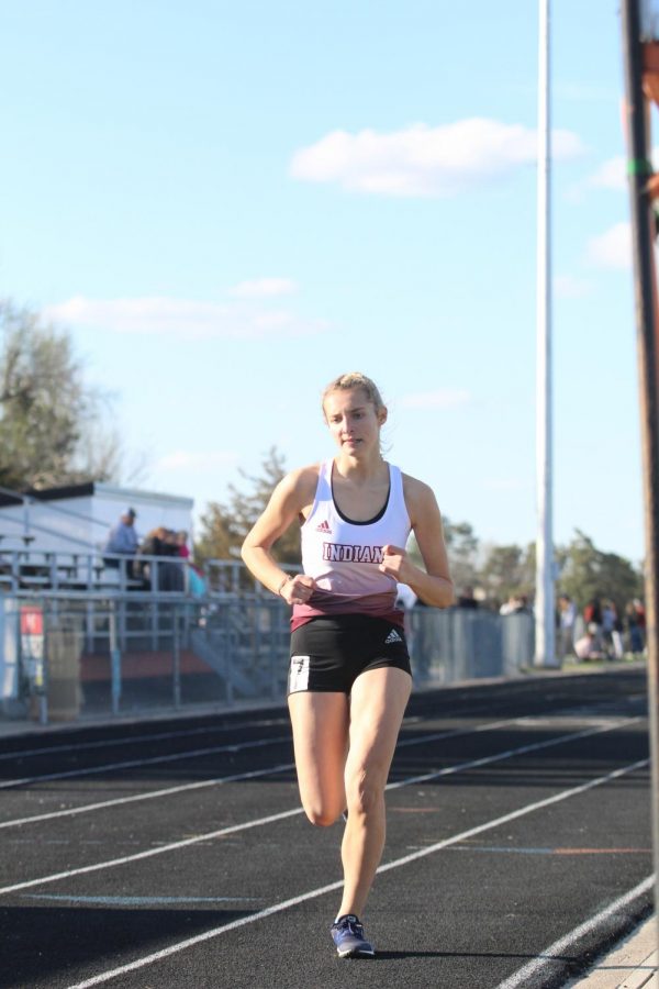 Sophomore+Kassie+Zimmer+races+at+a+previous+track+meet+in+Larned.+Recently%2C+the+girls+took+eighth+and+the+boys+took+seventh+at+the+Salina-Central+Invitational.