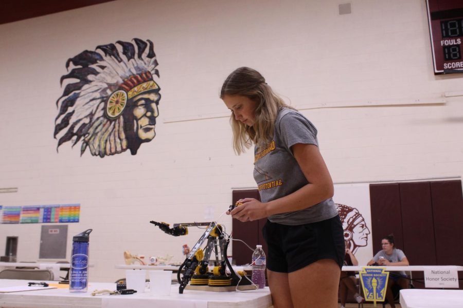 Junior Marrissa Raynesford operates the robitic arm for the Science Olympiad Team during PRIDE Night. 