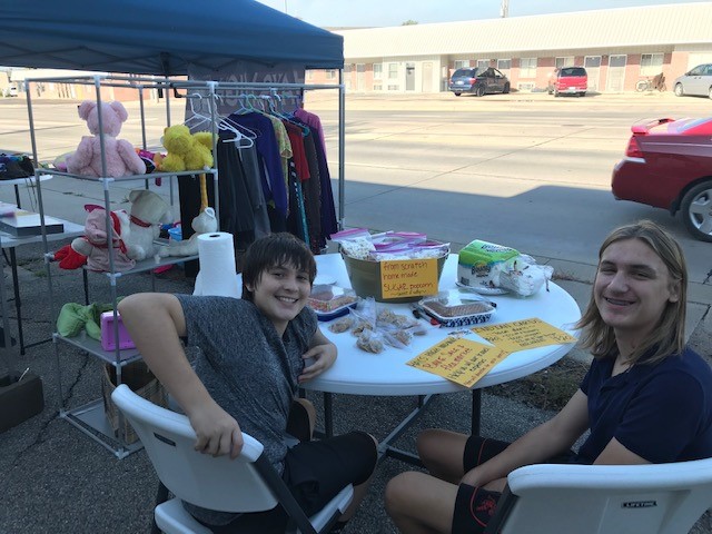 Freshmen Noah Bruggeman and Ansen Miner sell baked goods to raise funds for the Debate and Forensics team.