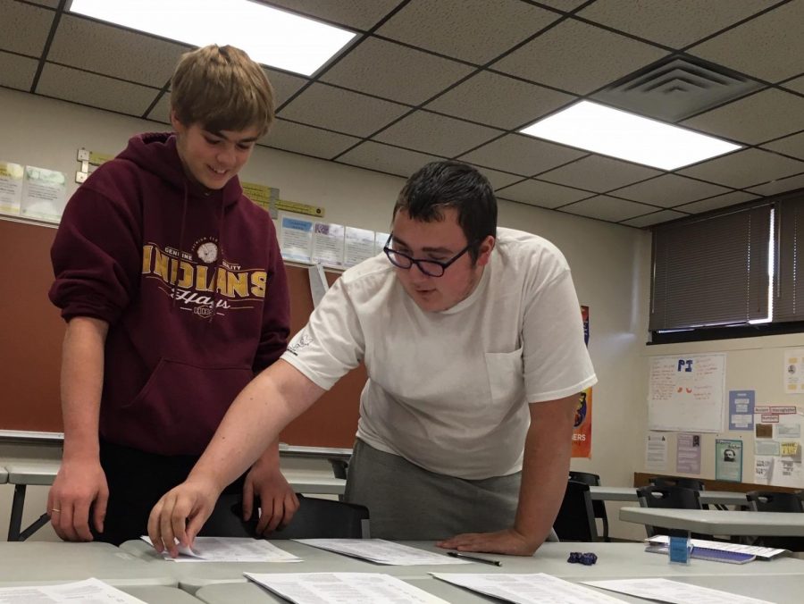 Juniors John Garner (left) and John Rupe (Right) look over character sheets during the Dungeons and Dragons meeting. The club met for the first time after school on Oct. 21 in room 121. Approximately 12 students attended the meeting.