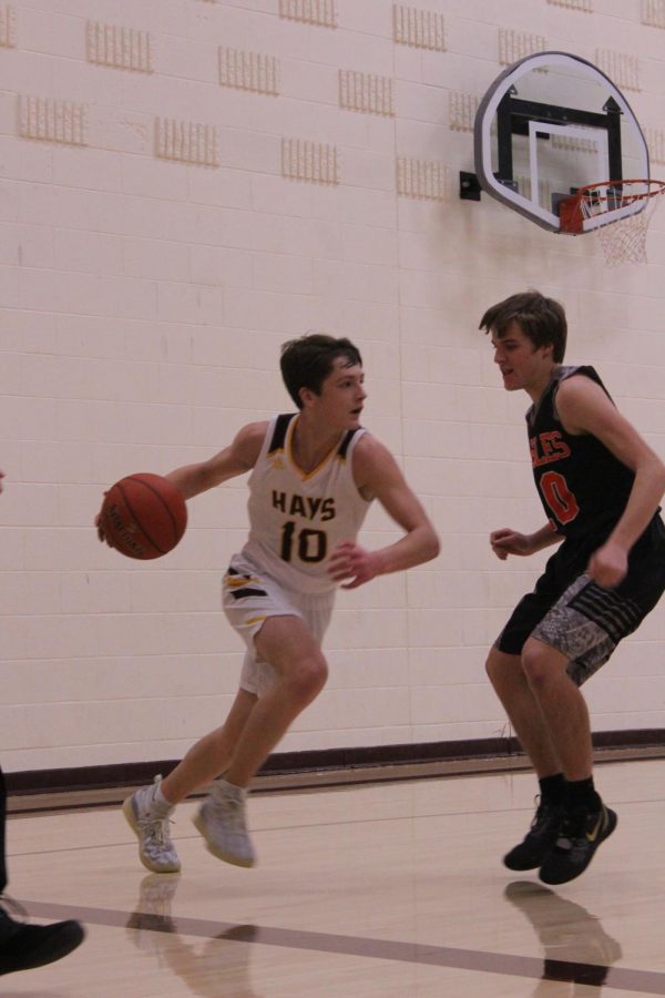 Sophomore Noah Weimer dribbles the ball during the game against Colby at home. 