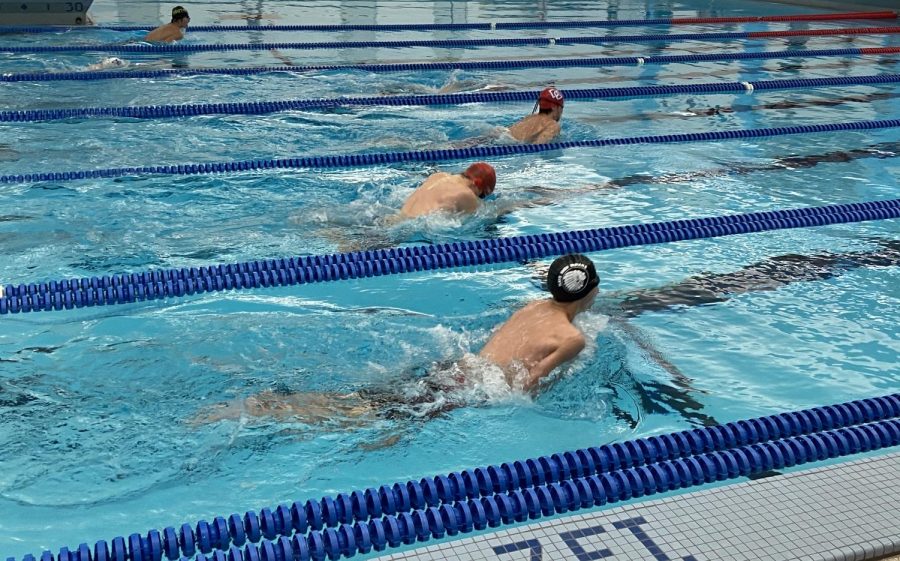 The swim boys rush to finish their breast stroke race. 