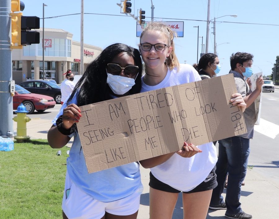 Senior Alicia Phlieger (left) and junior Aleyia Ruder (right) hold a sign during the protest on May 31. “This just shows that even in small communities we still have a voice, Phlieger said. Everyone around us has been welcoming and it’s good to see that we are all in this together.” 