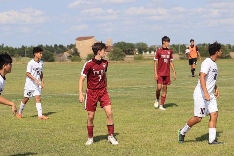 Sophomores Trayton Roa and Hector Amaya watch as the Garden City Buffaloes set up for a throw in during the game on Sept. 1.