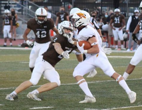 Junior quarterback/ running back Dylan Drieling stiff arms a Buffalo in game on September 25th in Garden City.