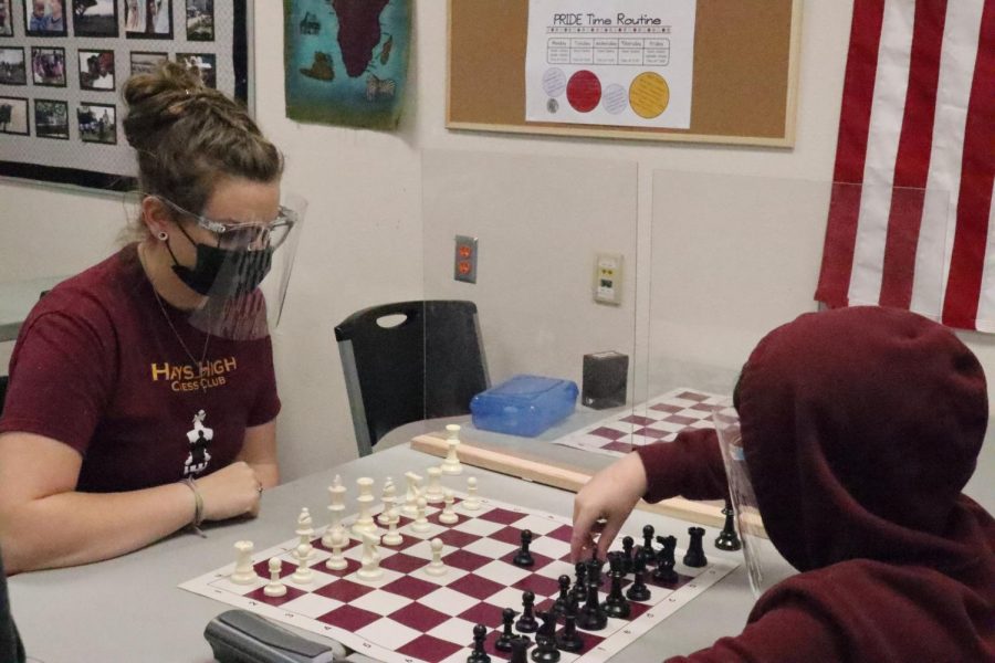 Sixth grader Kamden McBride practices with sponsor Erin Holder. McBride attends Chess Club meetings and meets up with the club to compete online. 