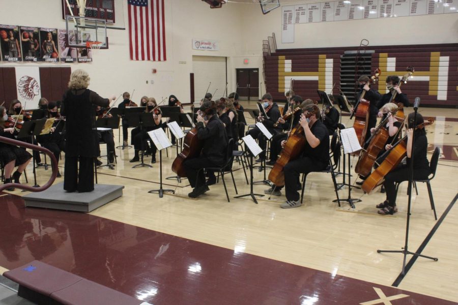 Joan Crull leads the orchestra at their winter concert.