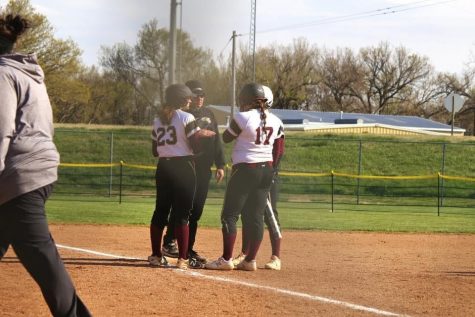 Assistant Coach Ty Berry Talks to some members of the softball team during a timeout called by Great Bend during the game that the Indians hosted on April 22. 