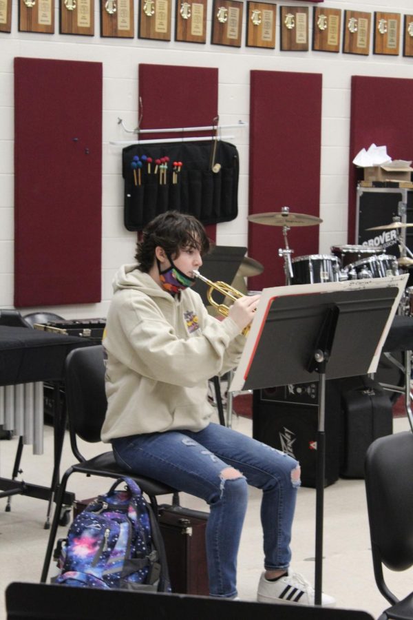 Senior Sophia Garrison warms up with her instrument in the band room before her class begins. Garrison has been involved in the band program for the duration of her high school experience.