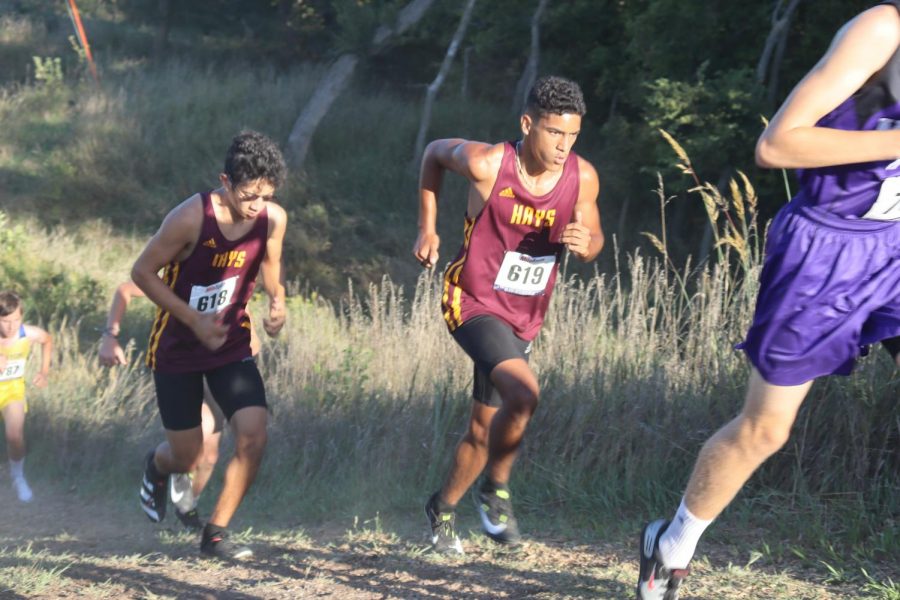 Senior Matthew Dempsey (left) follows behind sophomore Ty Dempsey while running up a hill. 