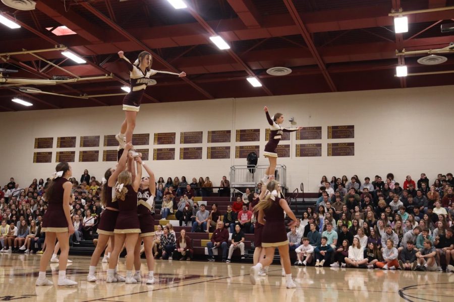 Cheerleaders+perform+during+the+pep+assembly+in+front+of+students.