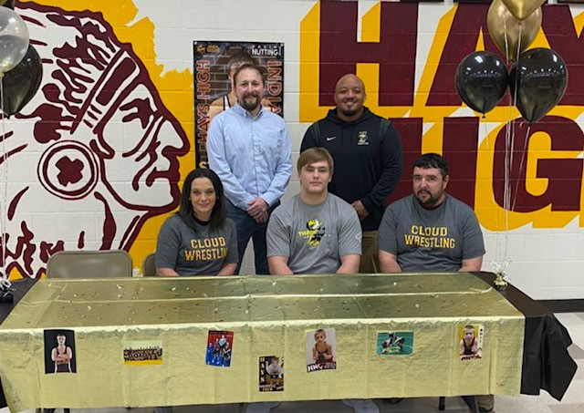 Senior Gavin Nutting poses with family a coaches after signing a letter of intent to wrestle for Cloud County Community College, or CCCC