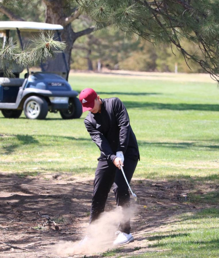 Junior Blake Buckles hits his second shot  on hole 8 at the Smoky Hill Country Club Invitational on April 18th.