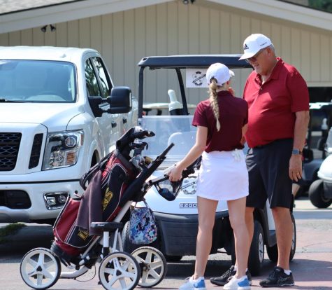 Senior Katie DInkel speaks with Coach Mark Watts at the Smoky Hill Country Club. Watts was named All-WAC coach of the year and Dinkel won All-WAC player of the year.