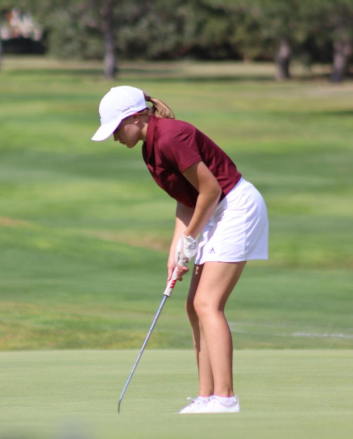Junior Abbie Norris putts at the Smoky Hill Country Club during the TMP invitational tournament