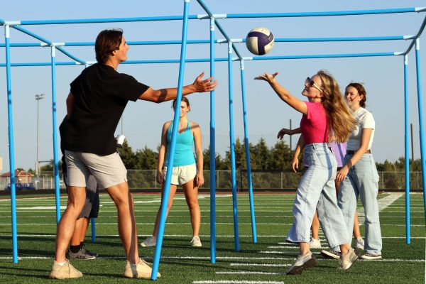 Senior Cooper L Johnson and junior Ava Erbert play 9-square with others at FCA's back-to-school party on Sept. 8.