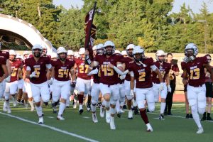 The Hays High football team takes the field before their matchup against Derby on Sept. 6, led by senior linebacker Wyatt Kirkpatrick.