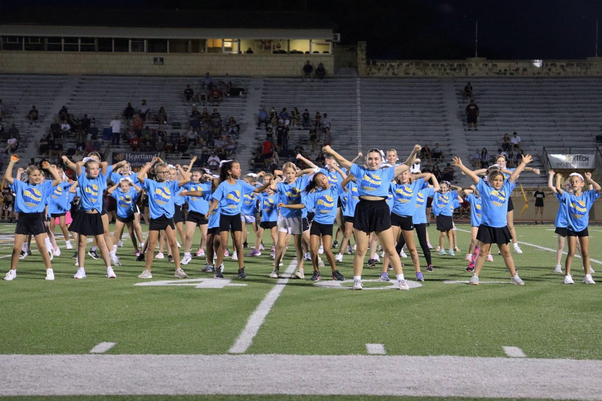 Senior Kaley Phelps leads the cheerleaders in their halftime show performance on Sep. 20.