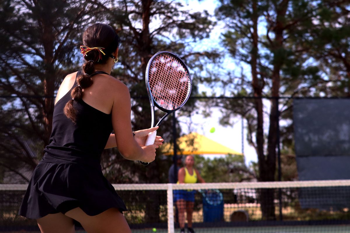 Senior Maycie Holdemen playing at the Hays home meet getting ready to hit the ball back. 