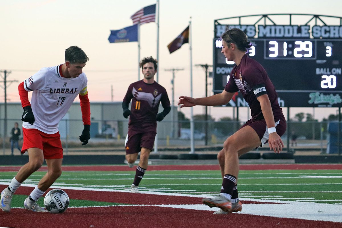 Seniors Cooper L. Johnson and Henry Speno play offense during the home game against Liberal. 