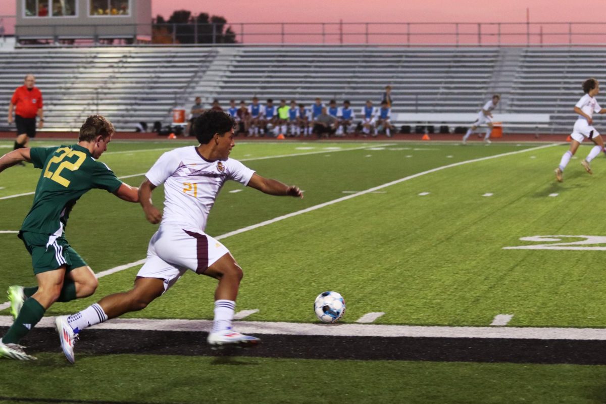 Sophomore Ivan Maldonado fights for the ball in game against Bishop Carroll High School. The Indians won the game 2-1 on October 28..