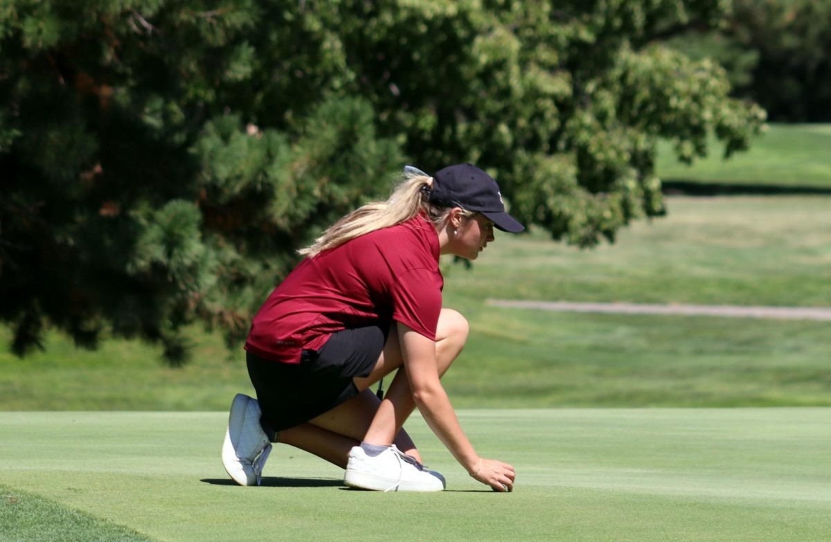 Junior Lily Butler prepares for her turn at a golf tournament earlier this year.