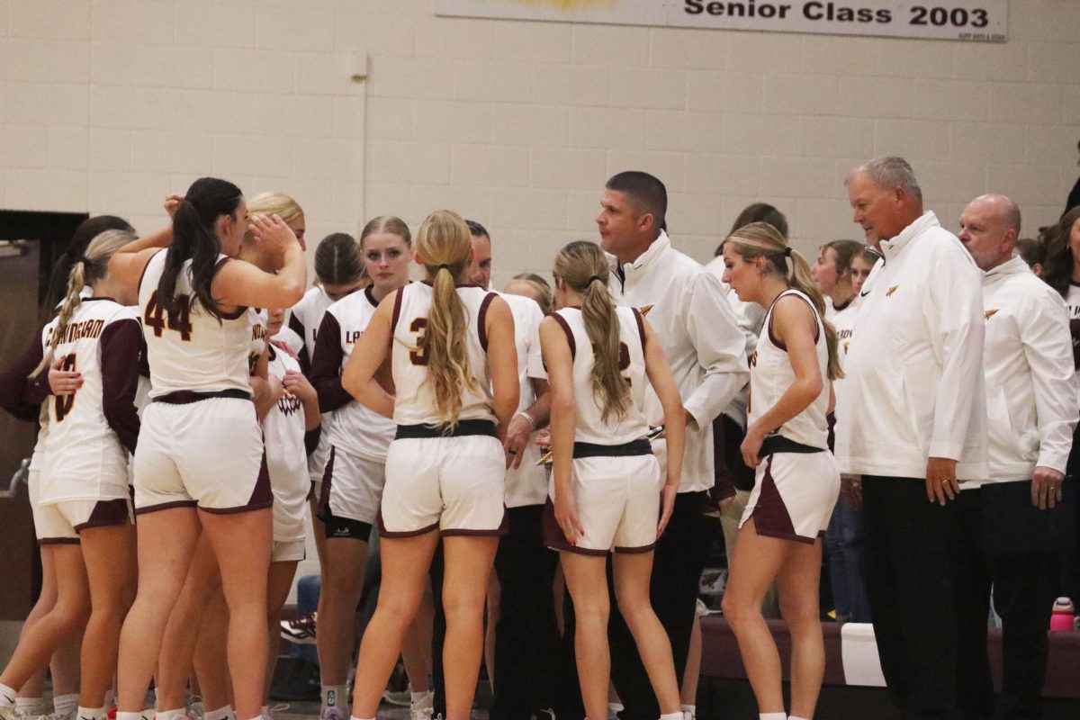 The Varsity team huddles during halftime of their game on Dec. 5, against Newton High School.