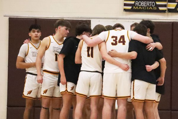 The Hays High School boys basketball team huddles up before their sub-state matchup against Hutchinson.