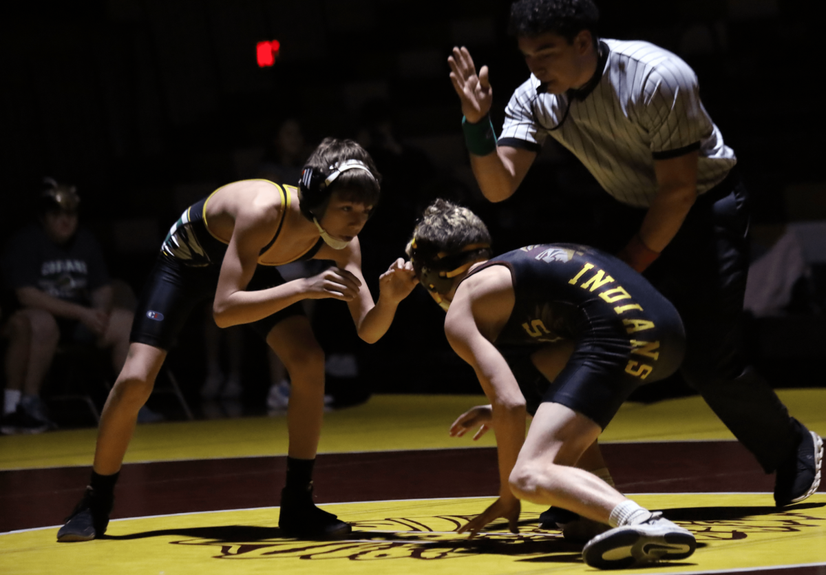 Sophomore Cyler Luck prepares to wrestle his opponent at the Salina South duel tournament held in Hays on Feb. 7.