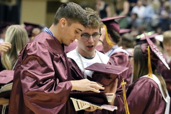 After the graduation ceremony, graduates Jack Zeller and Marshall Sook talk together on May 18.