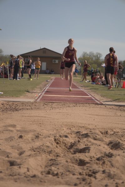 Junior Kamryn McCall prepares to jump in long jump while running down the runway at Pratt on April 11.