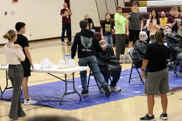 On Friday, May 16, teacher Matt Brooks get "pied" in the face by a student at a fundraiser assembly for the debate team.