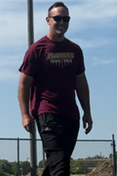 On May 13, Hays High School track head coach Kip Keeley walks around the high jump mat after watching senior Kamani Jones jump. The high jumpers were preparing for their Western Athletic Conference meet on May 15. Keeley said that this year, there has been “great improvement on the kids.” 