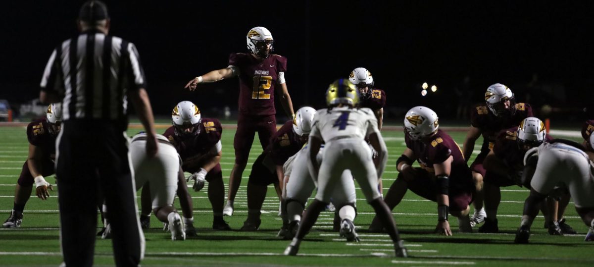 As the Hays High Indians prepare for the touchdown, senior Zane Viegra (12) leads the charge against the Choctaw Hornets at the new Hays High football field on Sept. 12.
