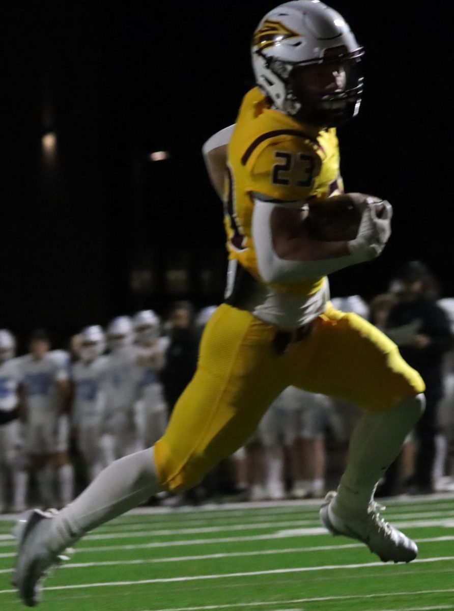 As the game begins, senior running back Holden Lind attempts to make points for the team at the Hays High vs Goddard-Eisenhower game on Nov. 7.
