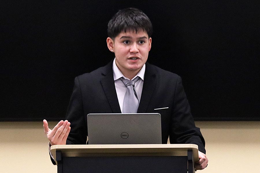 During a tournament on Dec. 13 at Hays High School, junior Mario Hernandez debates an opponent.