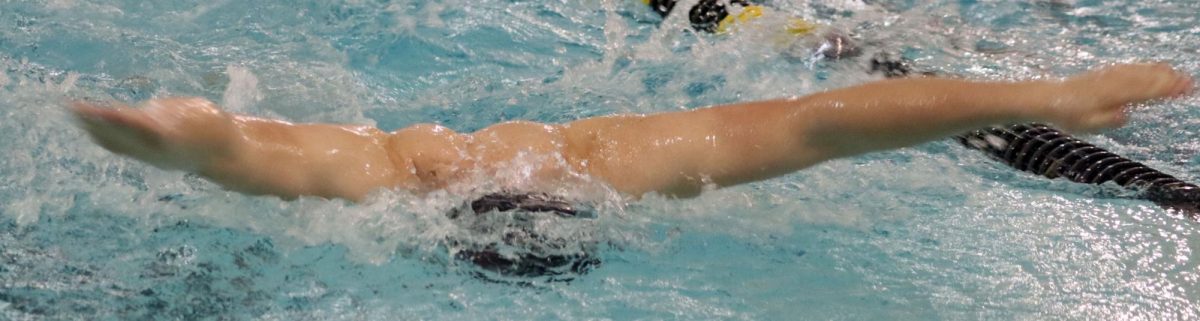 As his event continues, junior Cedric Durr tries to pull out ahead of the pack at the Hays High home swim meet on Jan. 20.