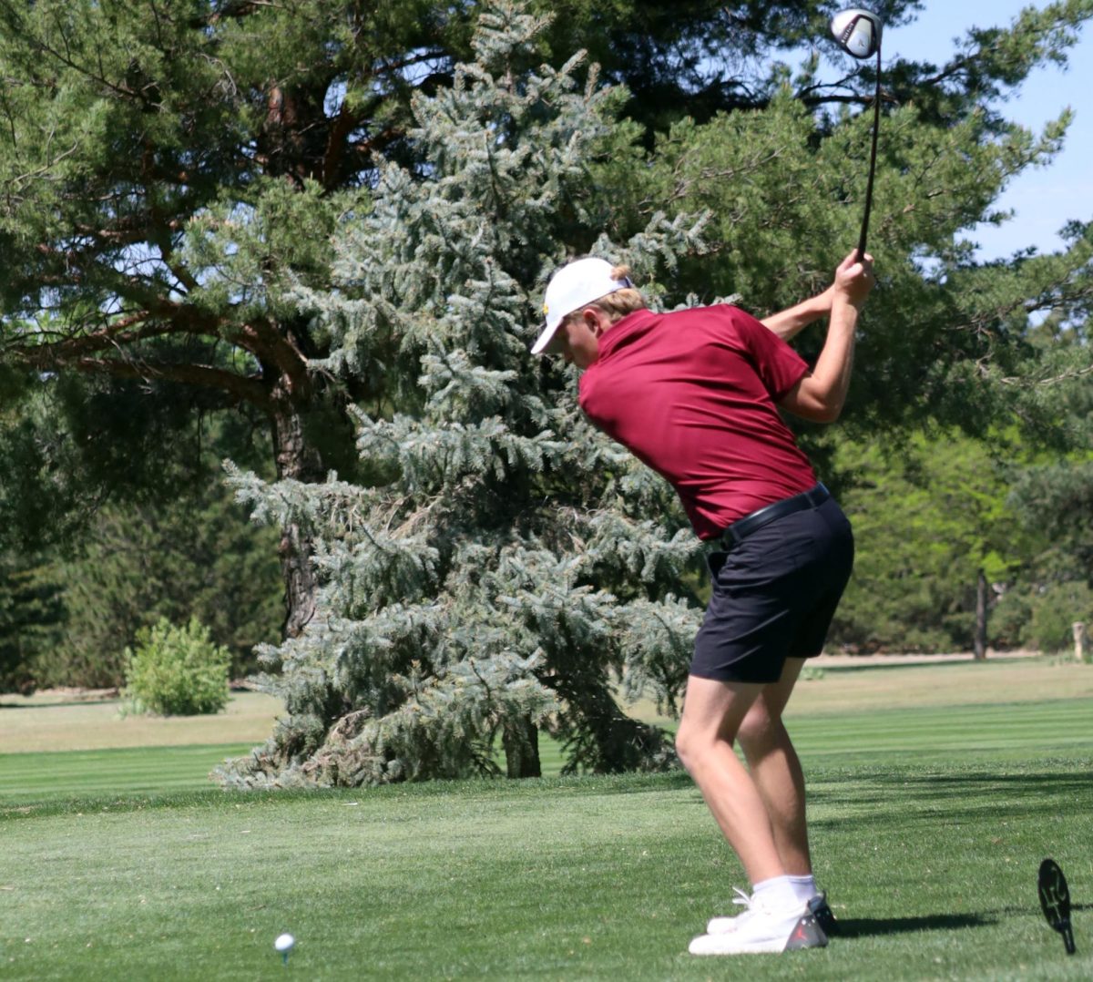 As the golf rounds continue, senior Braiden Bickle prepares to strike the ball at the Hays High Smoky Hill invitational on April 21.