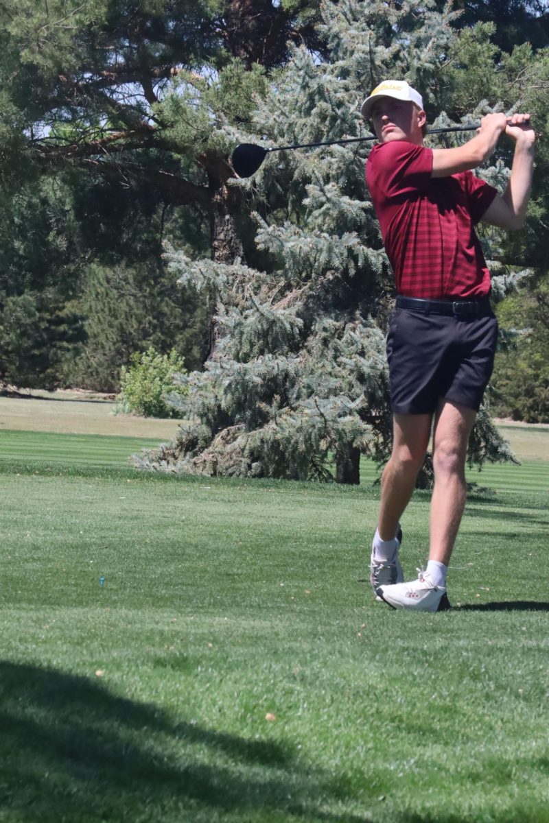 As the golf tournament commences, senior Parker Linenberger strikes the ball at the Hays High Smoky Hill game on April